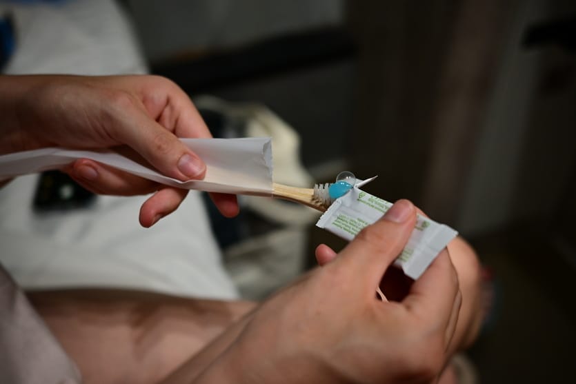 Toothpaste is applied to a toothbrush on the night train