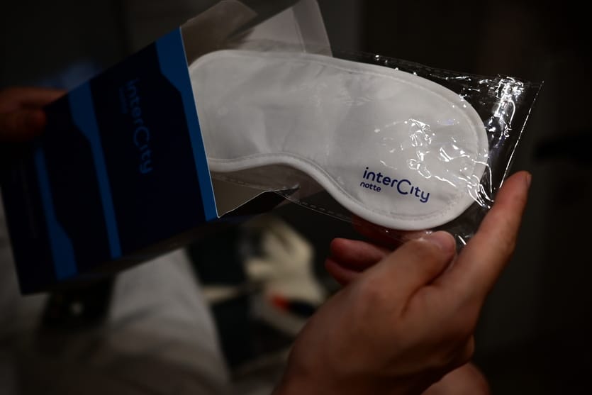 The goodie bag contains a white sleep mask