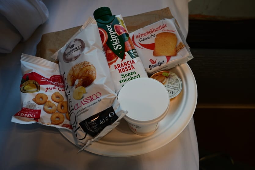 Various breakfast items packaged in plastic, including espresso