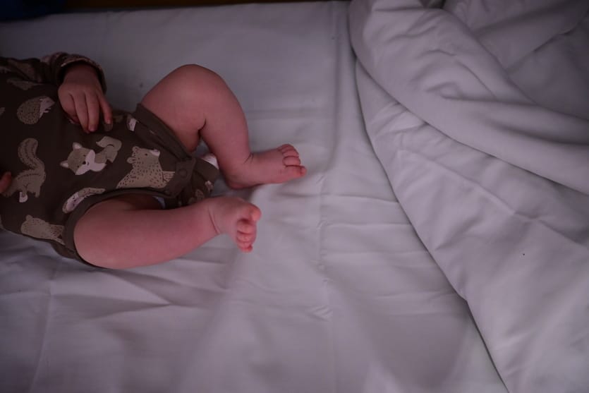 A baby lies on a nighttrain bed